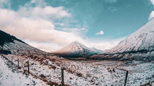 Scenic view of snowcapped mountains against sky