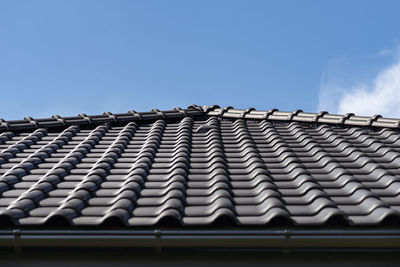 The roof of a house covered with a new ceramic tile, visible ceramic ventilation tile on the roof.