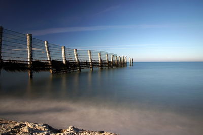 Pier over sea against sky