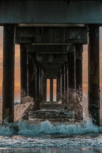 Water splashing on bridge against sky