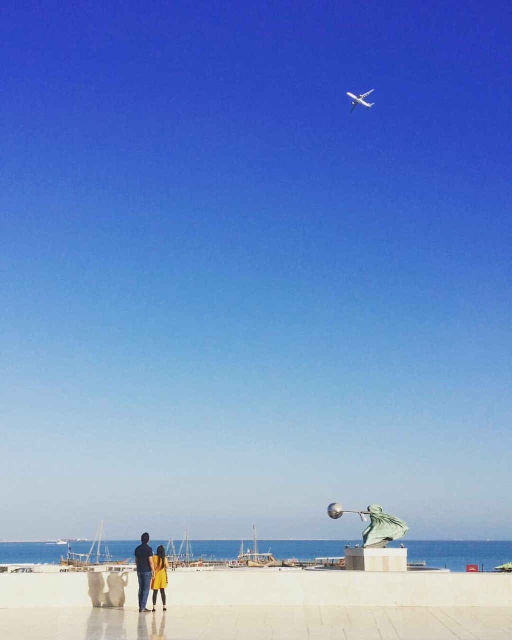 PEOPLE AT BEACH AGAINST CLEAR BLUE SKY