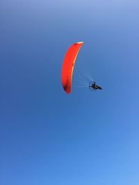 Low angle view of person paragliding in sky