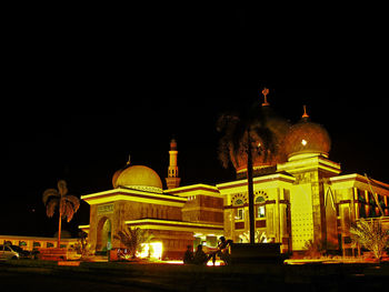 Illuminated temple against clear sky at night