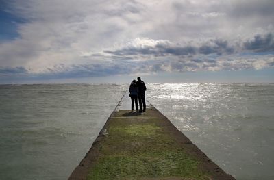 Scenic view of sea against cloudy sky