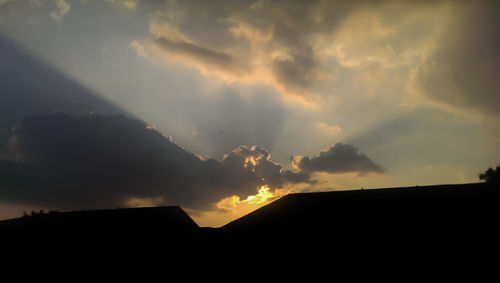 Low angle view of silhouette building against sky during sunset