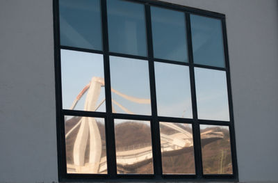 Reflection of sky seen through glass window of building