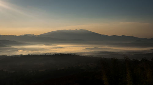 Scenic view of silhouette mountains against sky during sunset