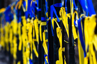 Ribbons with colors of ukraine during peaceful demonstration against war, ukrainian flag background