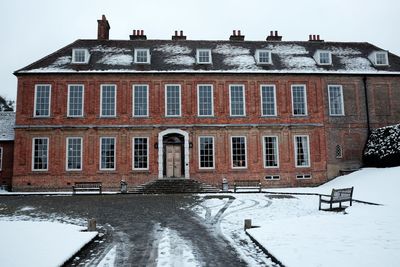 Snow covered building against sky