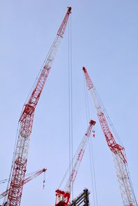 Low angle view of cranes against clear sky