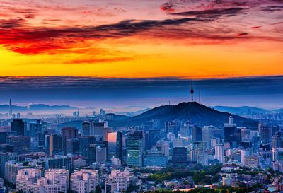 High angle view of buildings in city during sunset