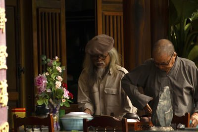 Two old vietnamese people praying together