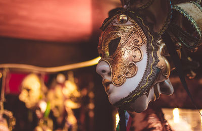 Close-up of mask hanging in store for sale