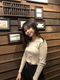 High angle view of woman sitting on wooden wall