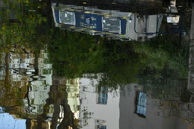 Reflection of building in puddle on lake