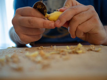 Midsection of person preparing food on table