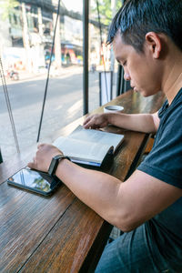 Side view of man working at table