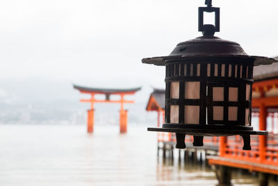 Lantern by mosque against sky