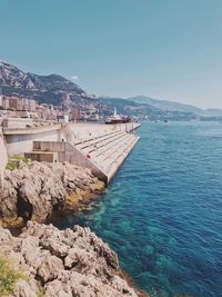 View of townscape by sea against clear sky