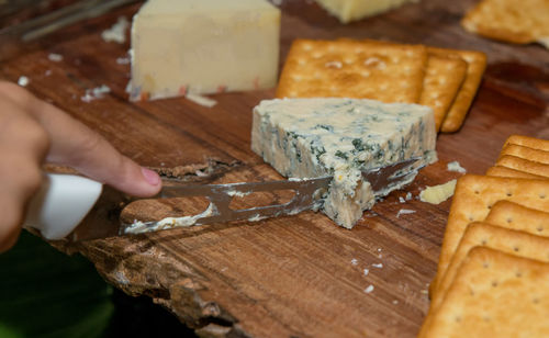 Close-up of person preparing food on cutting board