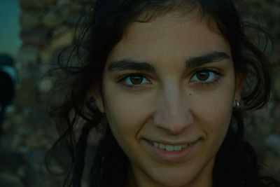 Close-up portrait of smiling young woman