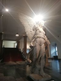 Low angle view of statue against illuminated building