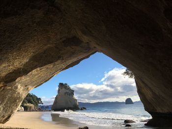 Scenic view of sea seen through cave