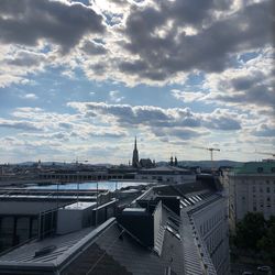 High angle view of buildings against cloudy sky