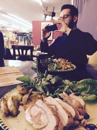 Woman eating food in restaurant