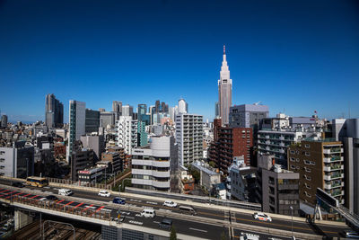 View of cityscape against blue sky