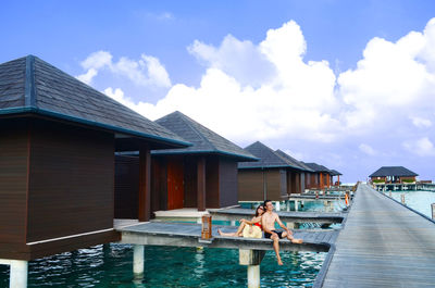 View of swimming pool by building against sky