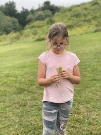 Full length of girl standing on field