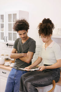 Young woman using laptop while sitting at home