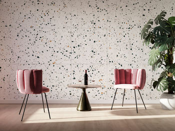 Empty chairs and table against wall at home