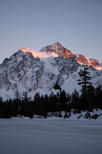 Scenic view of snowcapped mountains against clear sky