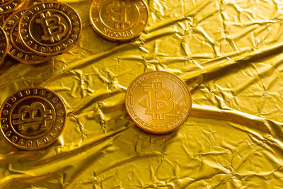 Close-up of bitcoins on golden paper