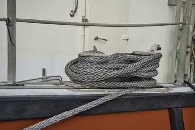 Close-up of rope on metallic table against wall