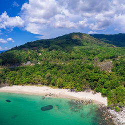 Scenic view of sea and mountains against sky