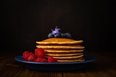 Close-up of strawberries on table against black background