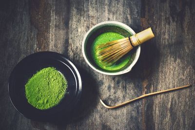 High angle view of green eggs in bowl on table