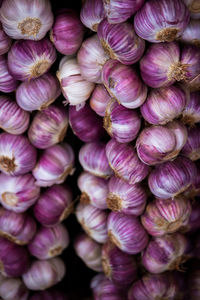 Full frame shot of onions hanging at market stall