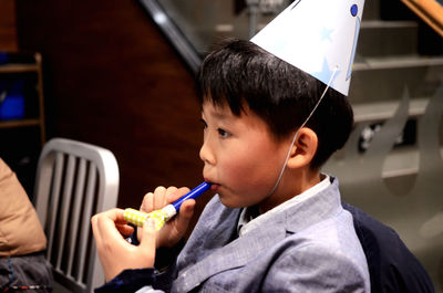 Portrait of boy holding at birthday celebration
