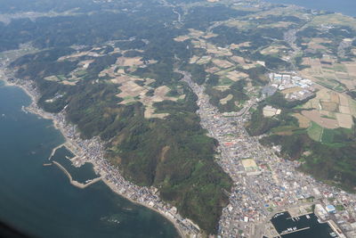 Aerial view of river amidst buildings in city