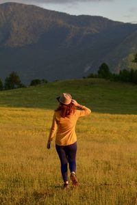 Rear view of woman on field