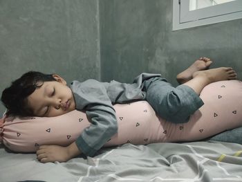 Sleeping kid hugging bolster