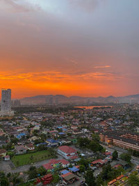 High angle view of buildings in city during sunset