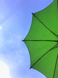 Low angle view of green umbrella against sky
