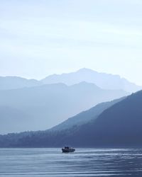 Scenic view of sea and mountains against clear sky