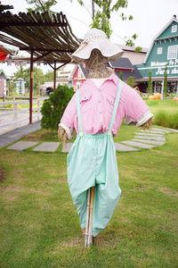 Rear view of woman with umbrella walking on field