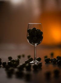 Close-up of black olives in glass on table